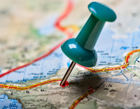 Close up image of a marker pointing to a specific location on a map, representing geographic positioning and site identification.の素材