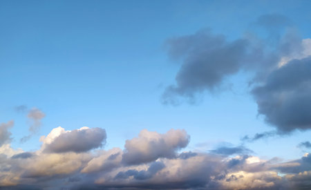 Clear blue sky texture and white fluffy cloud nature background. The sun shines bright in the daytime in summer. Soft sunlight on panoramic image. Heaven, peace concept and copy space. Peaceful and tranquil atmosphere.の写真素材