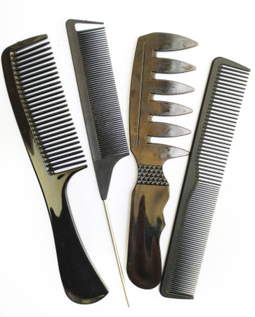 Stylish black combs of various designs, neatly arranged on a white background. Perfect for hair styling concepts, beauty blogs, or barber shop imagery. Implies order, grooming, and selfcare.の写真素材