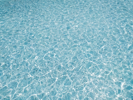 Serene, turquoise water shimmers under sunlight. Perfect for backgrounds, website headers, or travel brochures, this image evokes calmness and tranquility.の写真素材