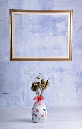 Vintage photo frames and flowers on a blue textured background. Place for your textの写真素材