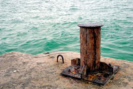 An old rusty bollard on a pier