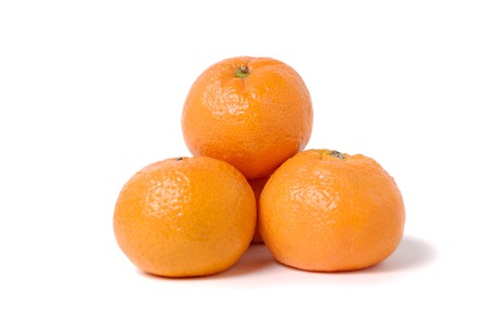 Four tangerines in the form of a pyramid on whiteの写真素材