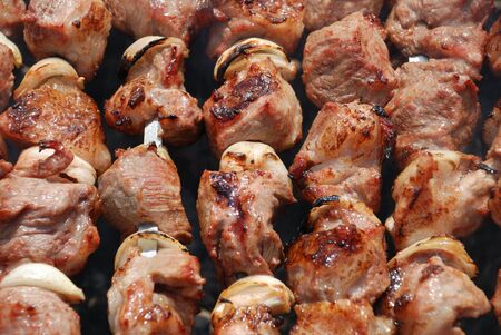 Preparation of meat slices in sauce on fireの写真素材
