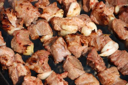 Preparation of meat slices in sauce on fireの写真素材