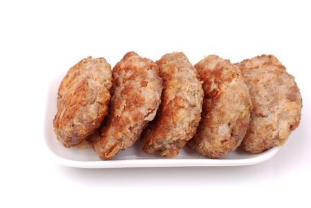 meat formed into a ball on a white plate