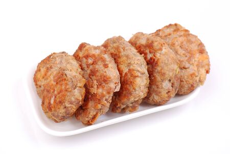 meat formed into a ball on a white plateの写真素材