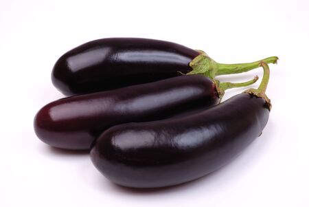 Three whole eggplants on a white backgroundの写真素材