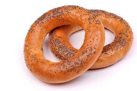 Two big bagels with a poppy on a white backgroundの写真素材