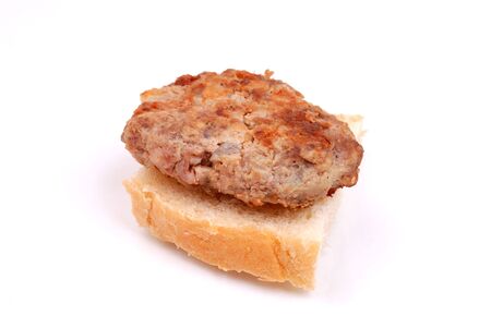 meat formed into a ball on a small breadの写真素材