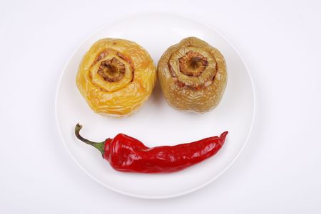 Stuffed paprika and red pepper smiling on a plateの写真素材