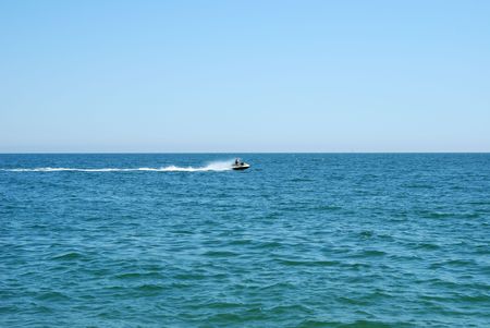 Man on a high speed jet ski with water spray
の写真素材