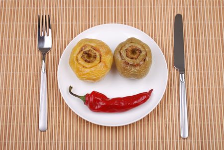 Stuffed paprika and red pepper smiling on a matの写真素材
