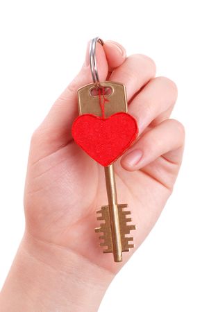 The woman hand holds a key to heart on whiteの写真素材
