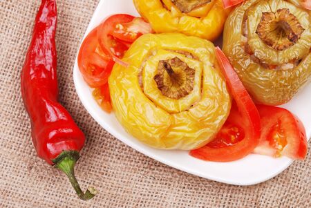 Stuffed paprika and tomato on a plate の写真素材