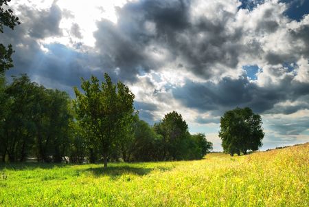 Landscape with the bright sun and the storm skyの写真素材