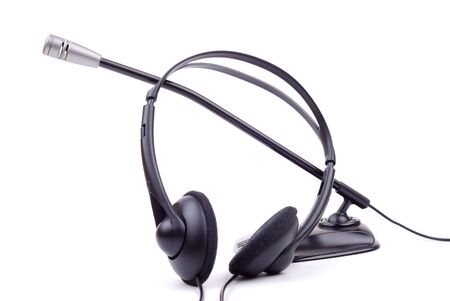 The black generic headphones and microphone isolated on whiteの写真素材