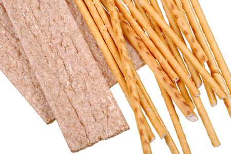 Stack of salted breadsticks and bread isolated on white