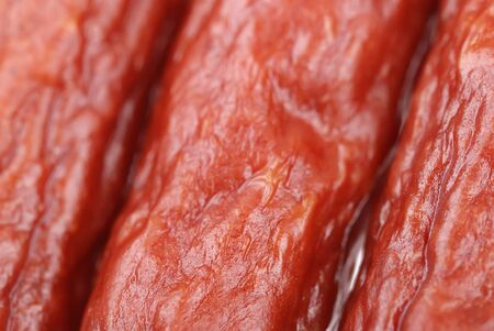 Background of tasty sausages on white
