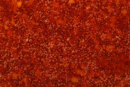 Macro image of red jelly background with bubblesの写真素材