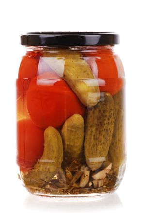 The clear glass jar of colorful pickled vegetables isolatedの写真素材