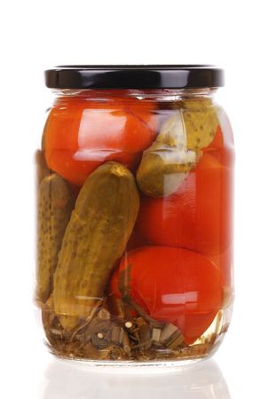 The clear glass jar of colorful pickled vegetables isolatedの写真素材