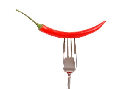 Red hot chili pepper pricked on the steel fork isolated