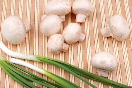 Composition from vegetables. Champignons and onion on a mat.の写真素材
