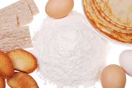 Pancake on a dish, a handful flour, and eggs isolatedの写真素材