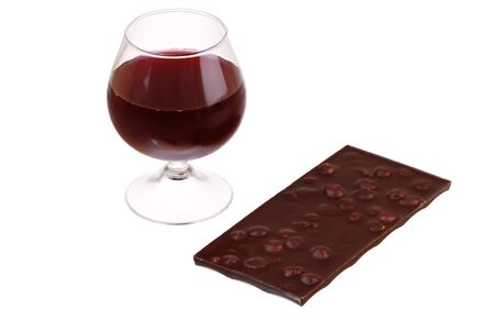 Red wine glass and chocolate over a white backgroundの写真素材