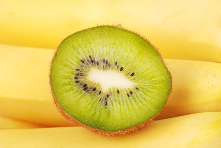 Closeup of the kiwi slice on banana backgroundの写真素材