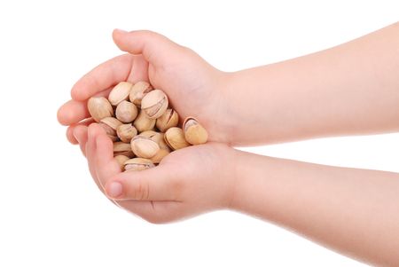 The children's hand holds nuts isolatedの写真素材