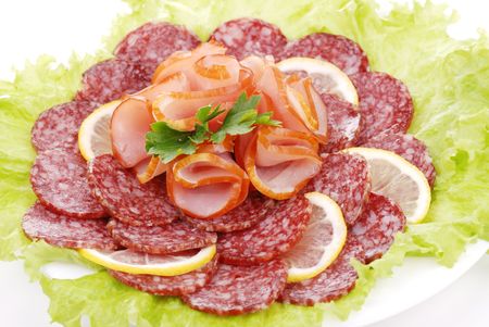 Tasty sausages and greens on a plateの写真素材