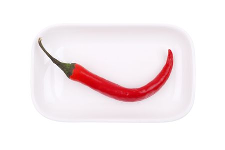 Red hot chili pepper on white dish isolatedの写真素材