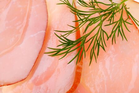 Slices of bacon as background and dill
