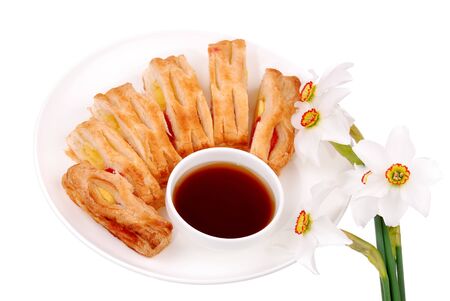Fresh buns and flowers on white plate isolatedの写真素材