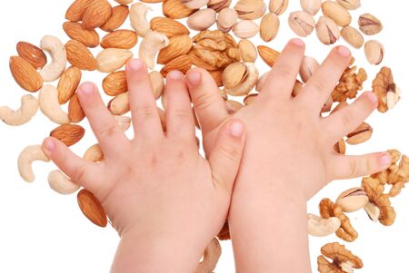 The children's hand holds nuts isolatedの写真素材