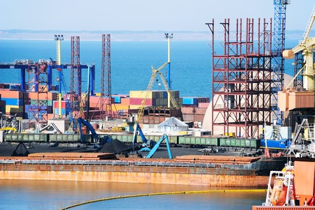 View on trading seaport with cranes, cargoes and the ship