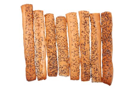 Stack of salted breadsticks with poppy seed isolated on white