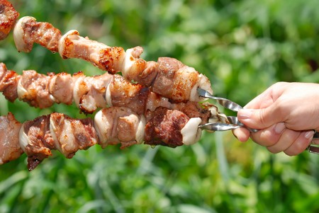Juicy slices of meat with sauce prepare on fireの写真素材