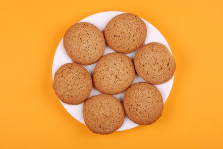 The plate with cookies on a yellow backgroundの写真素材