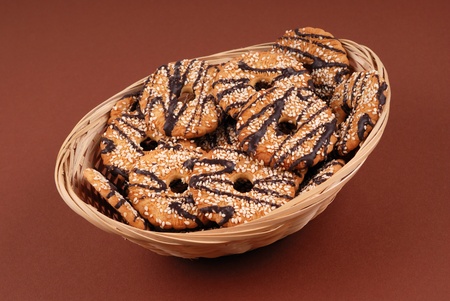 Basket with cookies in chocolate glaze on whiteの写真素材
