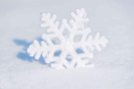 big snowflake toy in snowdriftの写真素材