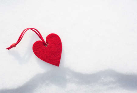 heart toy on snow backgroundの写真素材