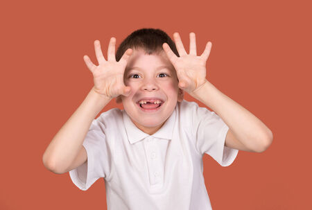 boy portrait in white shirt on brownの写真素材