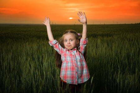 girl fun and grimacing at sunsetの写真素材