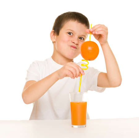 boy drink orange juice with a strawの写真素材