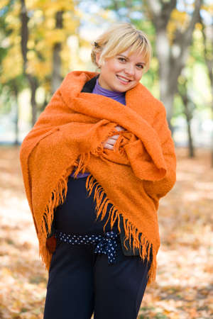 pregnant woman in autumn parkの写真素材