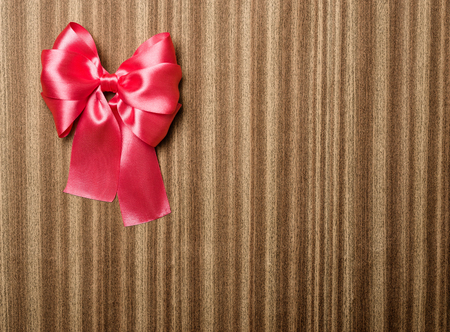 red bow on wooden backgroundの写真素材