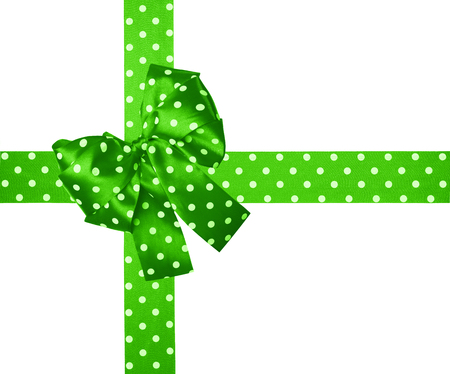 green  bow and ribbon with white polka dots made from silk isolatedの写真素材